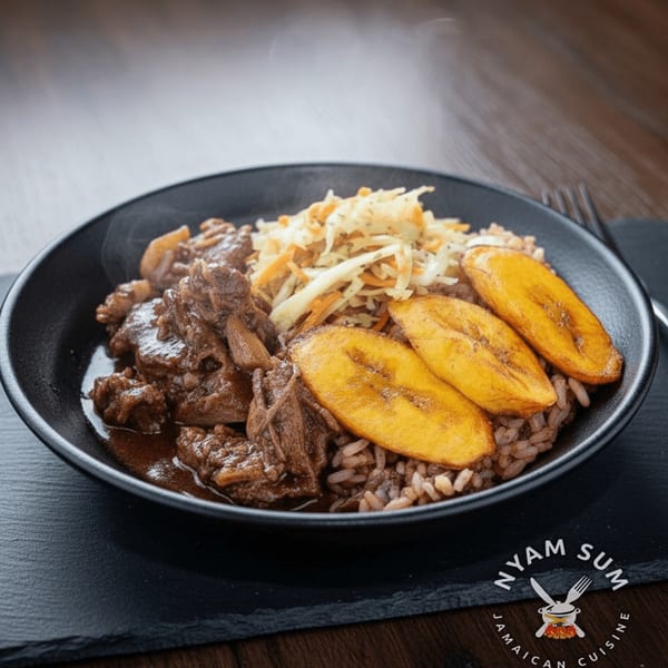 Steaming Jamaican brown stew chicken with rice, coleslaw, and fried plantains in a black bowl.