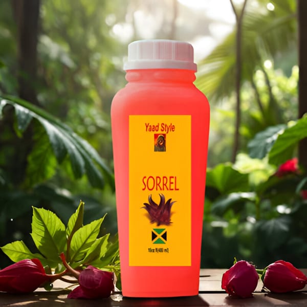 A red bottle of Yaad Style Sorrel drink with a yellow label, surrounded by green leaves and red flowers.