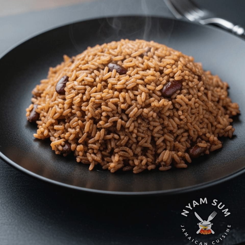 Steaming Jamaican rice and peas, a Nyam Sum specialty, served on a black plate.