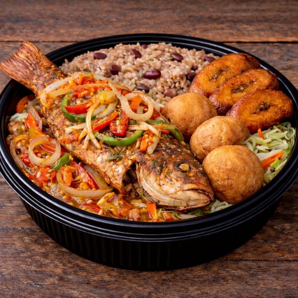 Whole fried fish with peppers and onions, rice and beans, fried plantains, and dumplings.